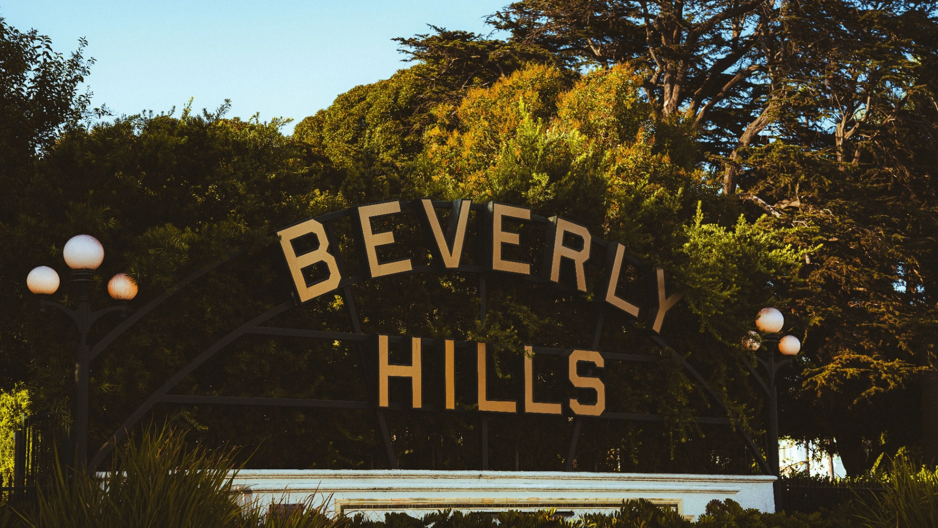 Beverly Hills sign shaded by mature tree canopy